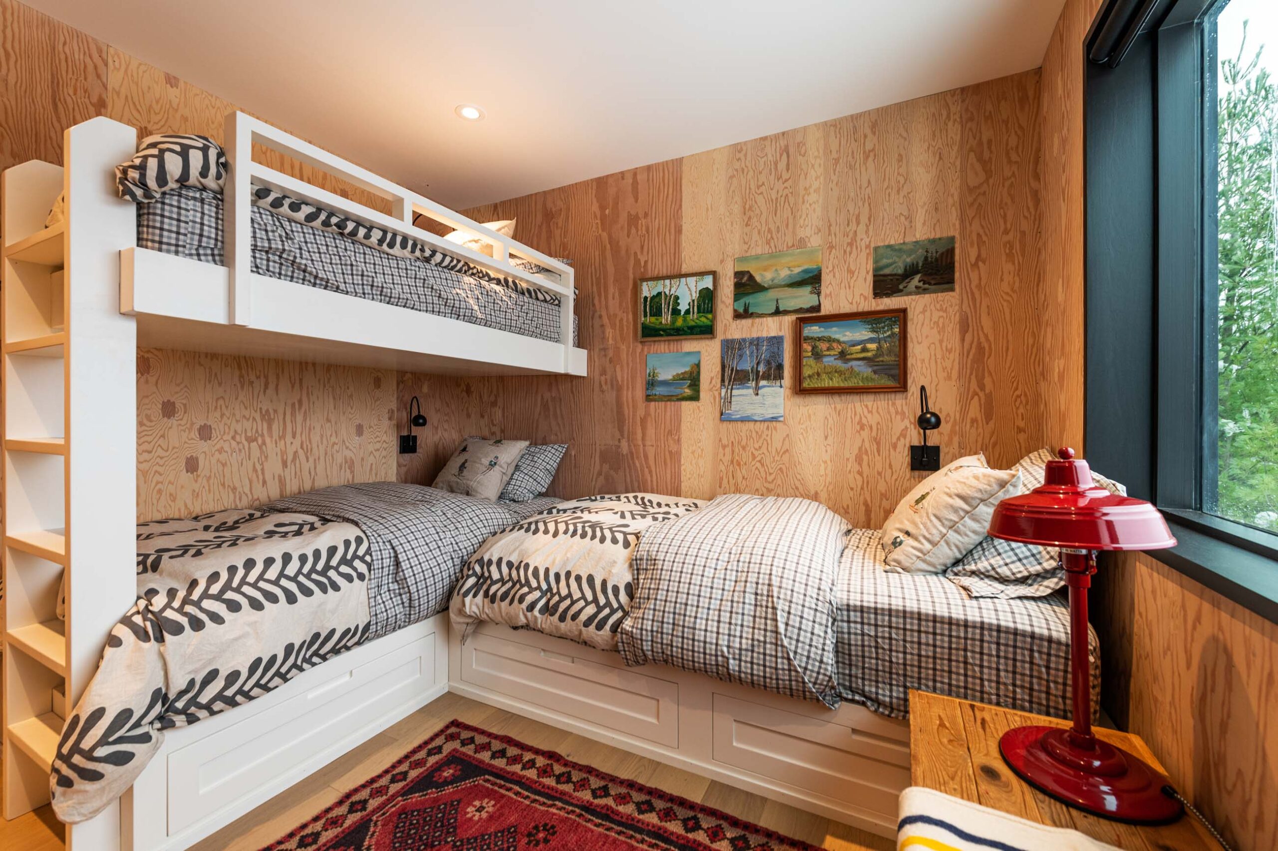 Bedroom with built-in bunk beds in a Custom Scandi-style Cabin built by Blake Farrow Project Management Inc.