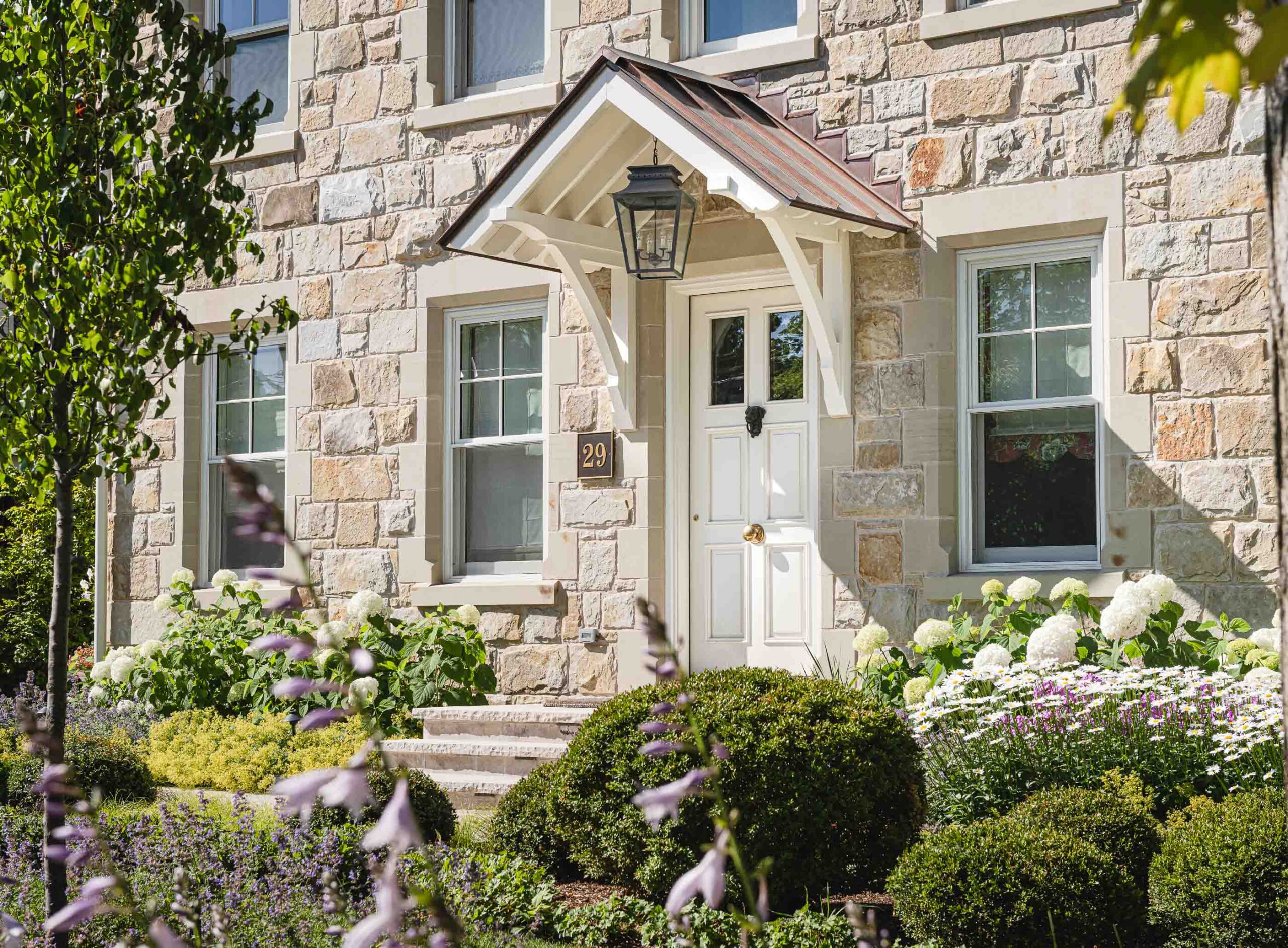English cottage-style stone house built by a Collingwood custom home builder
