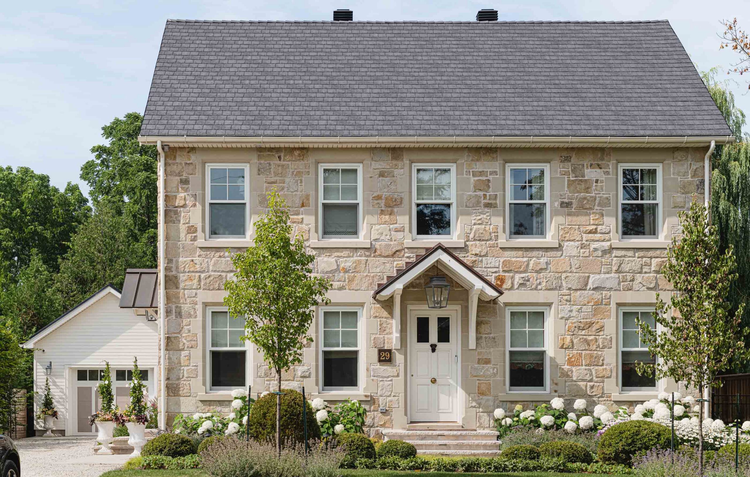 English cottage-style stone house built by a Collingwood custom home builder