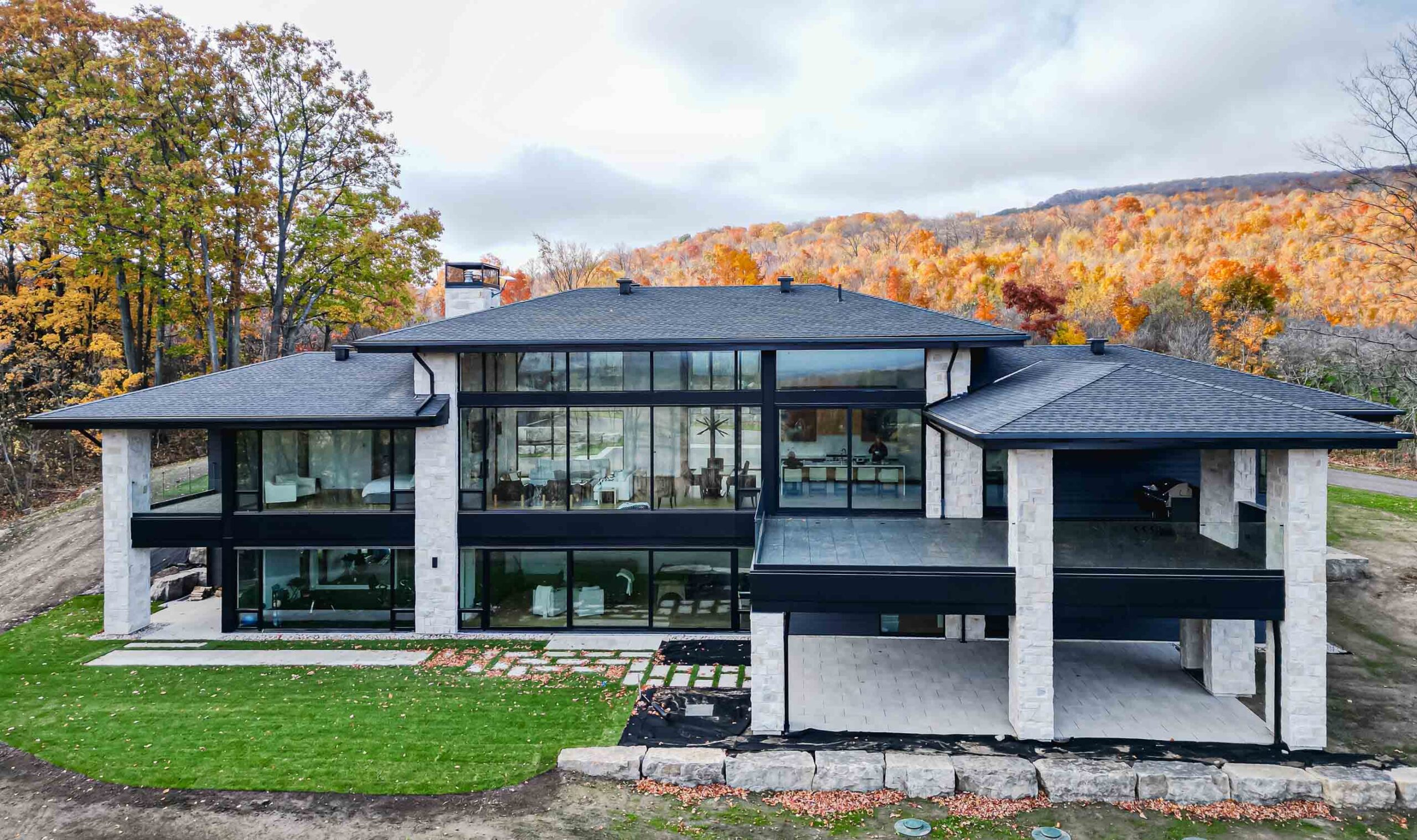 Autumn exterior of a contemporary country home with floor to ceiling windows