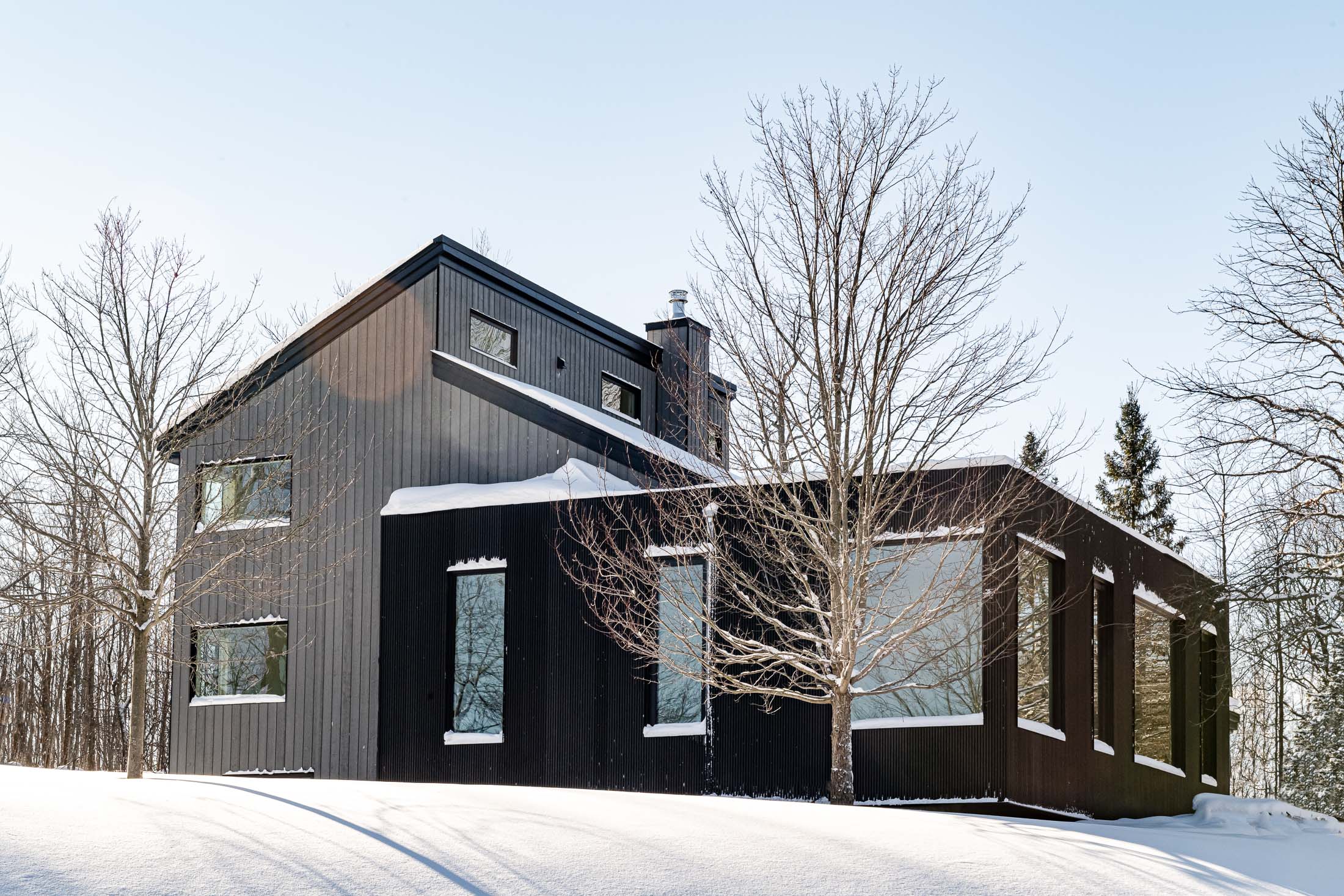 Exterior of a grey highlands chalet renovation with a modern addition