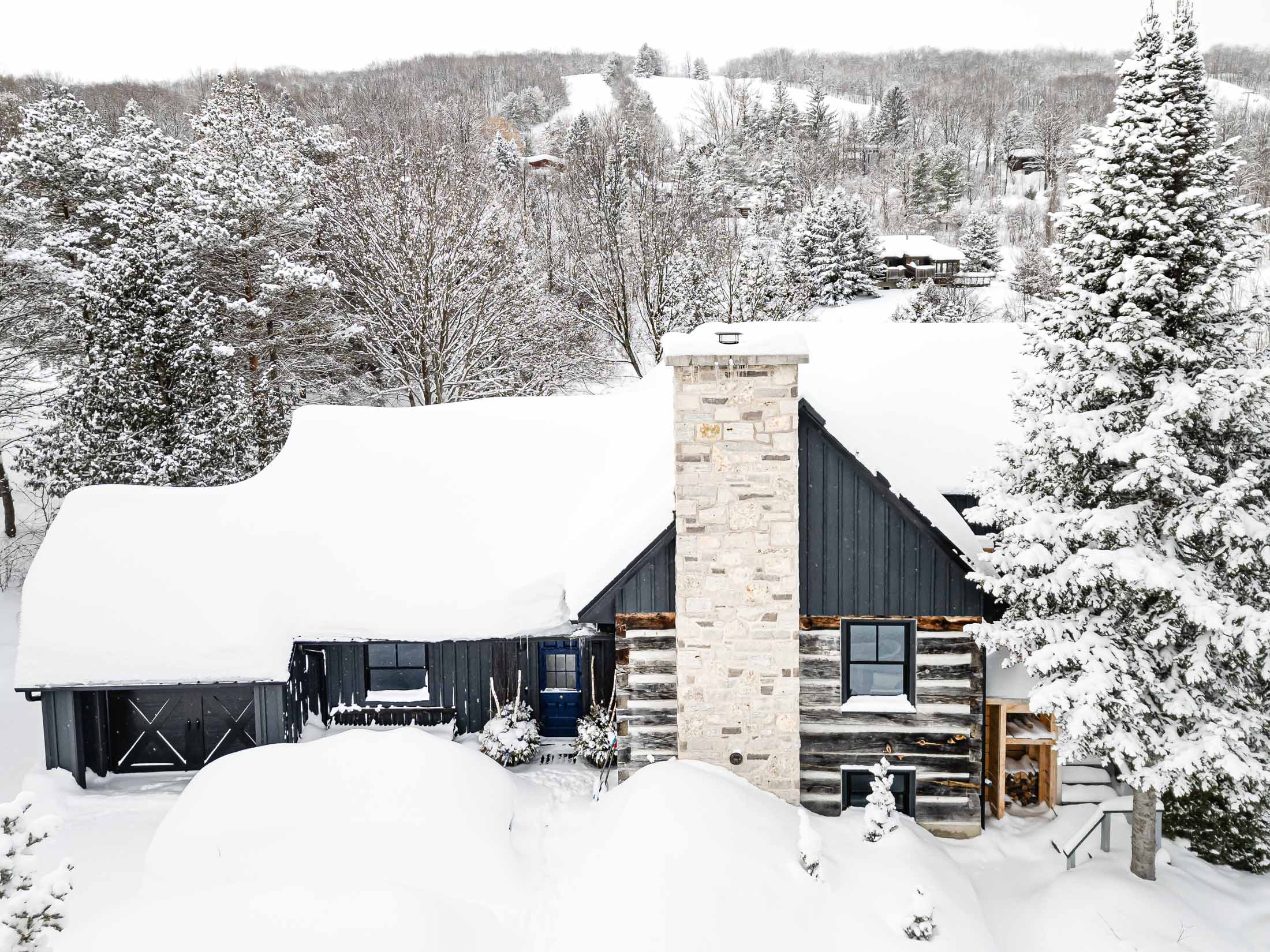 Exterior of a renovated chalet featuring an original log cabin with a modern addition