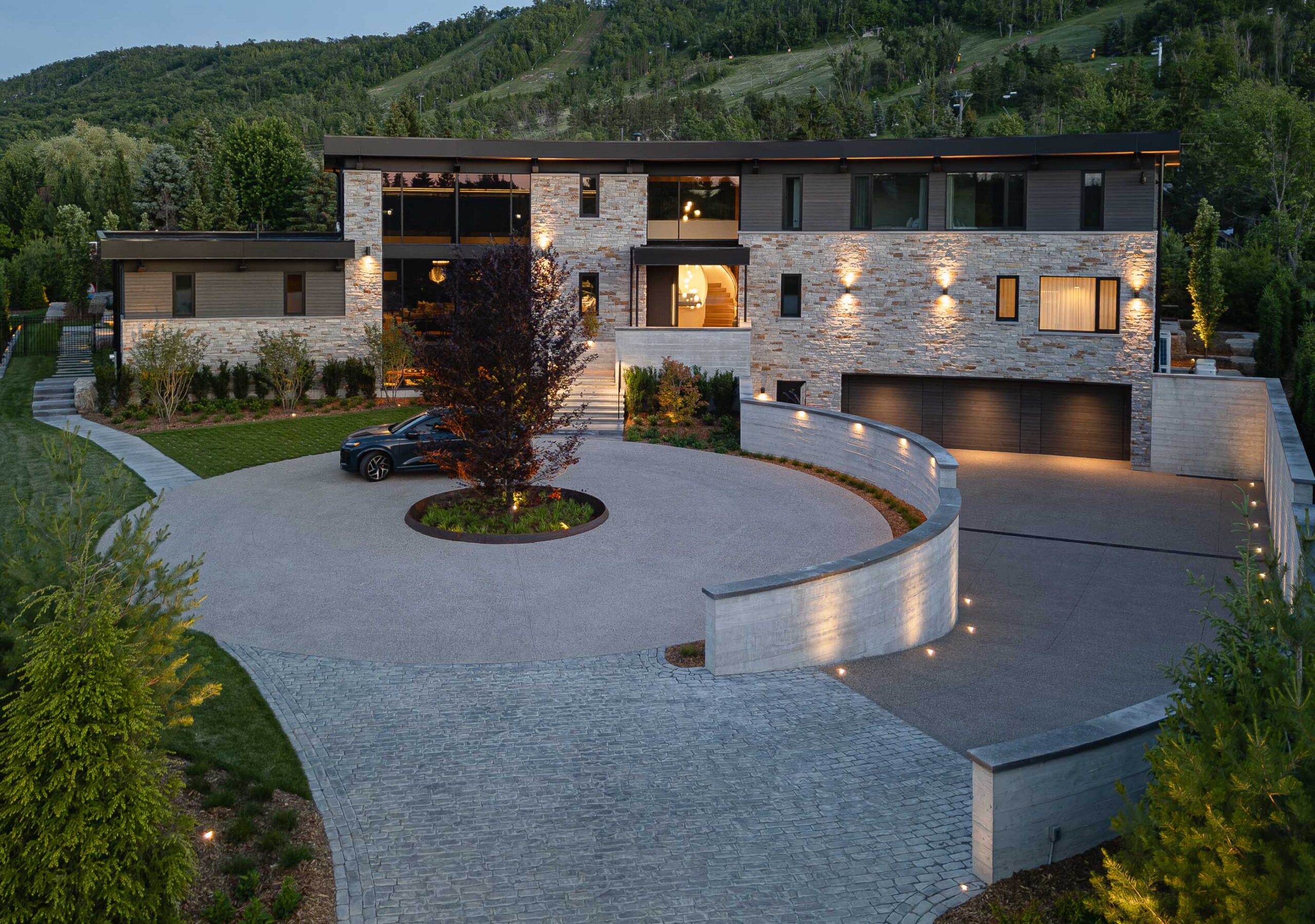 Front elevation view of a luxury chalet with distinctive curved architecture, built by a Collingwood custom home builder