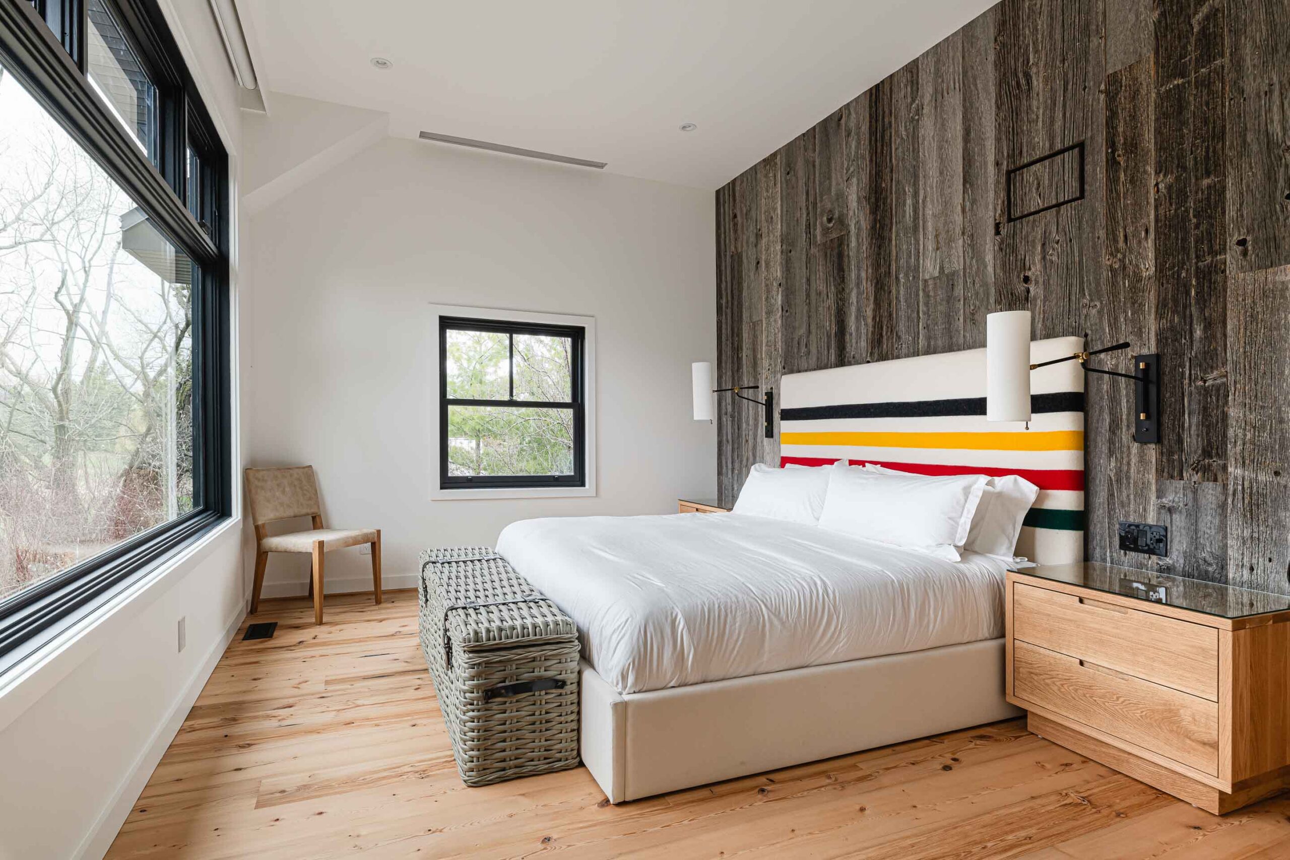 Modern rustic bedroom with barn board feature wall headboard in a chalet renovation by Blake Farrow Project