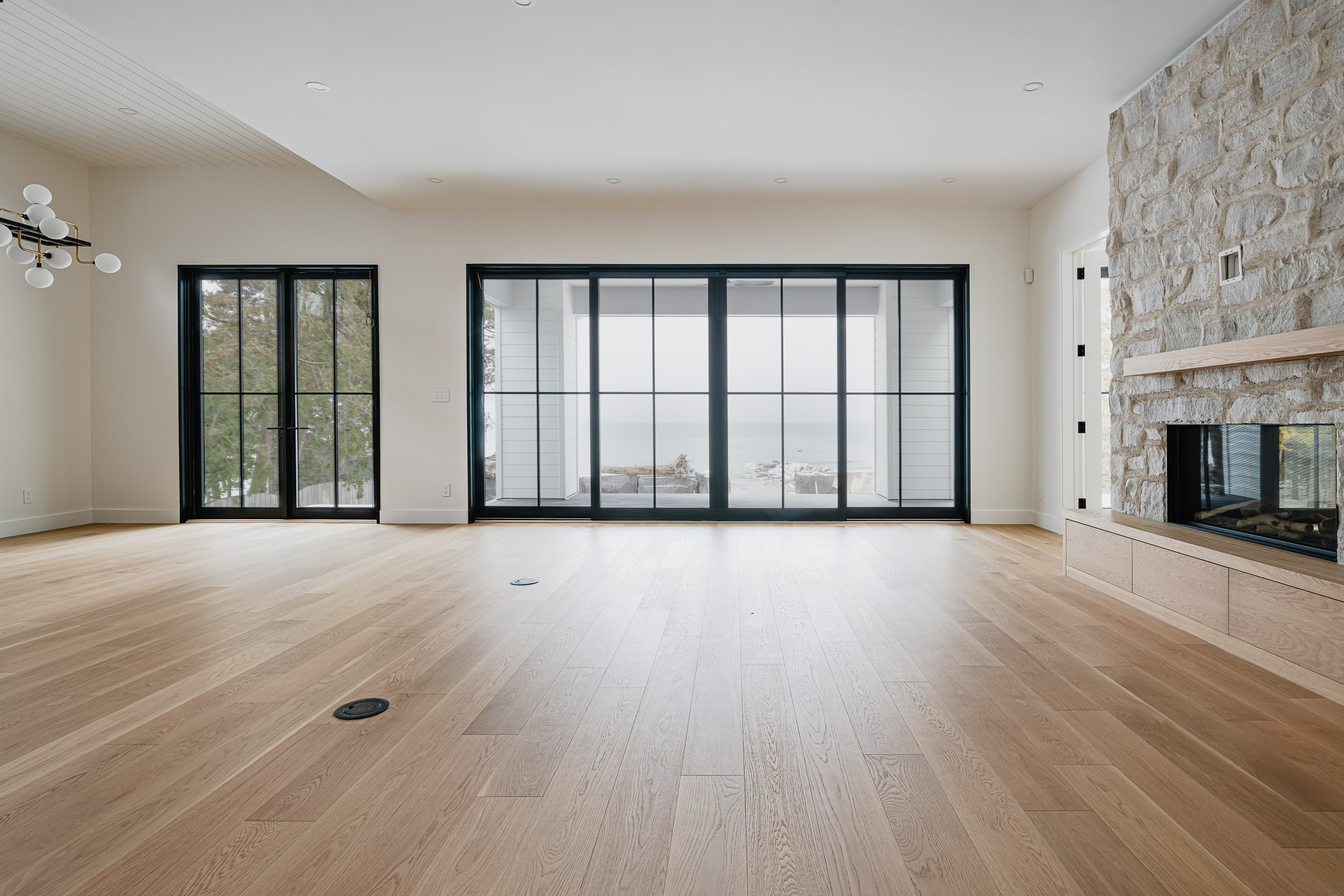 interior living room of a waterfront modern beach house built by blue mountain custom home builder