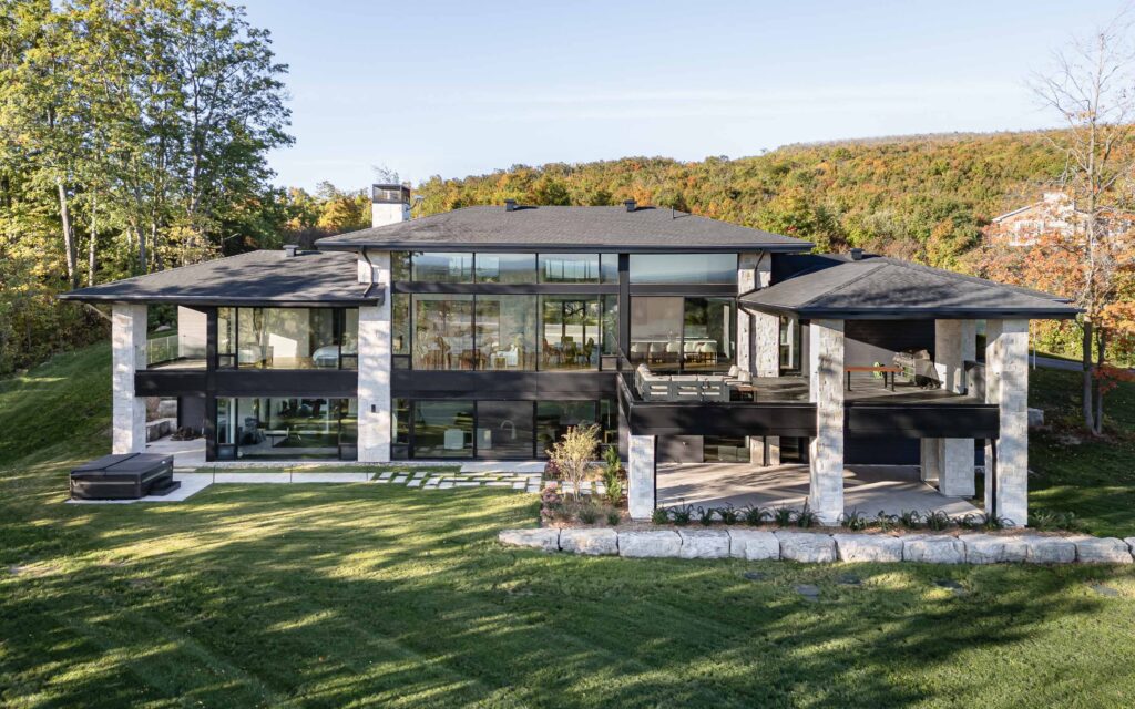 Modern country home with expansive glazing, stone detailing and manicured landscaping