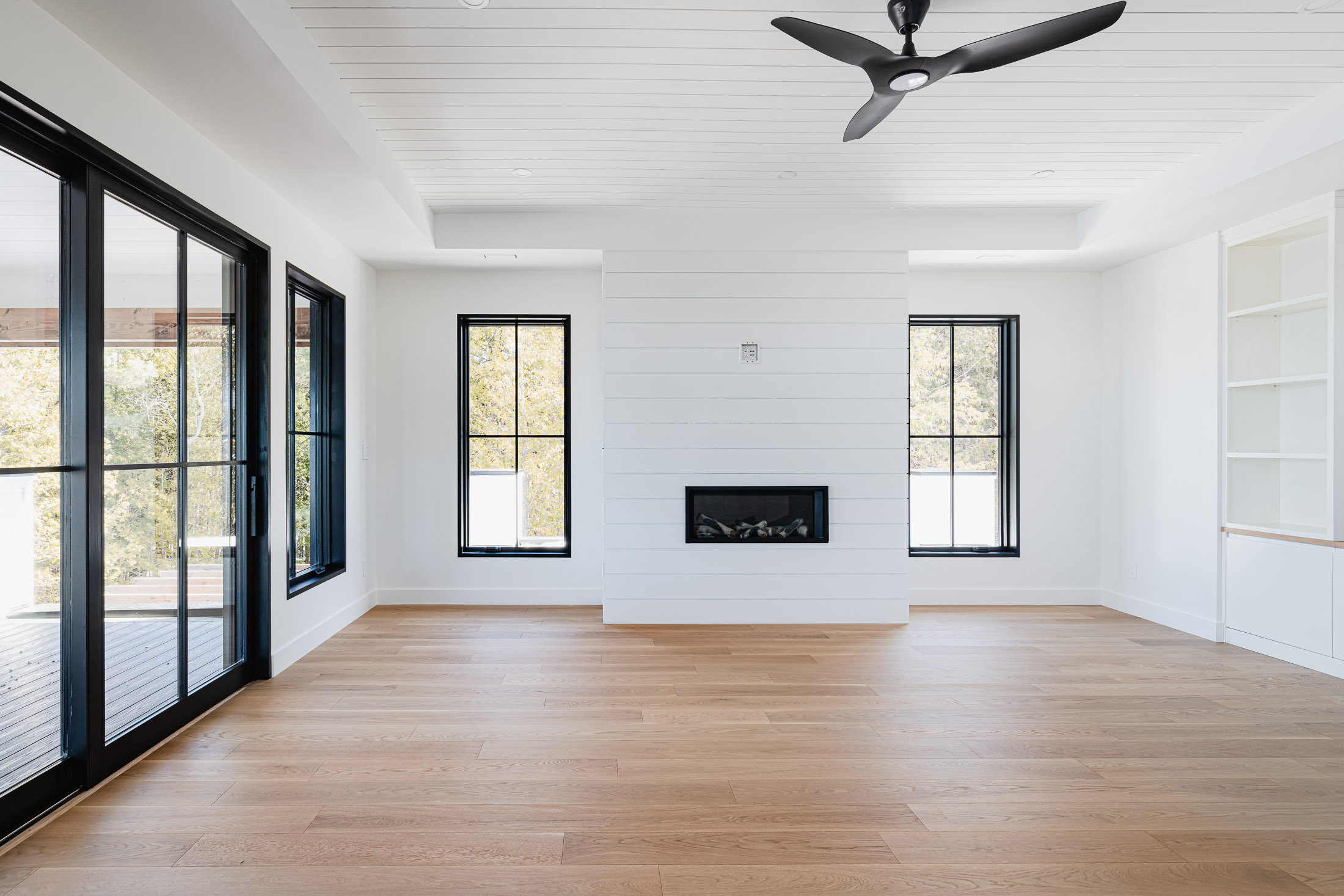 Primary bedroom in a blue mountain beach house interior with shiplap design elements