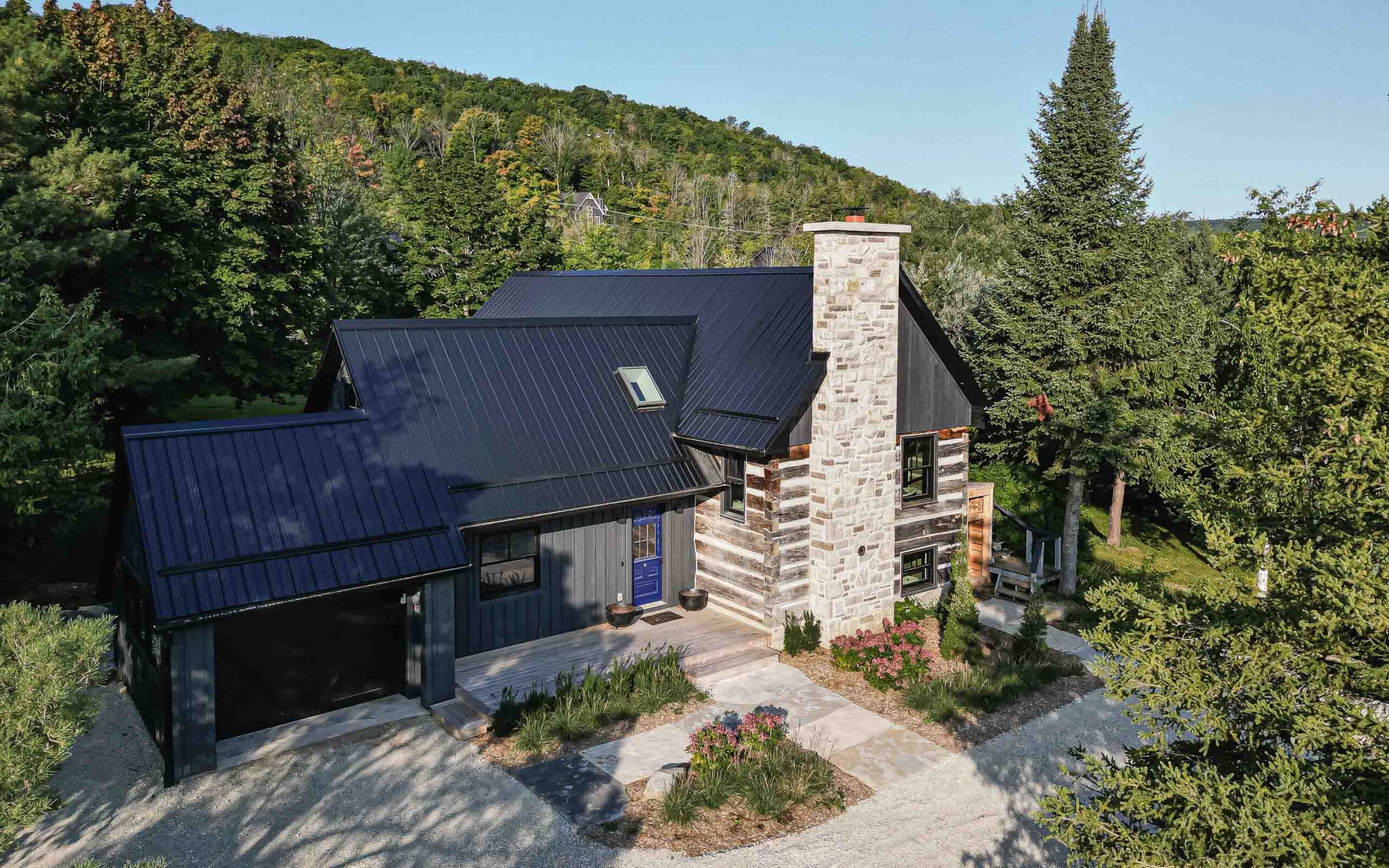 exterior of a rustic log cabin renovation with a contemporary addition, built by Blake Farrow Project