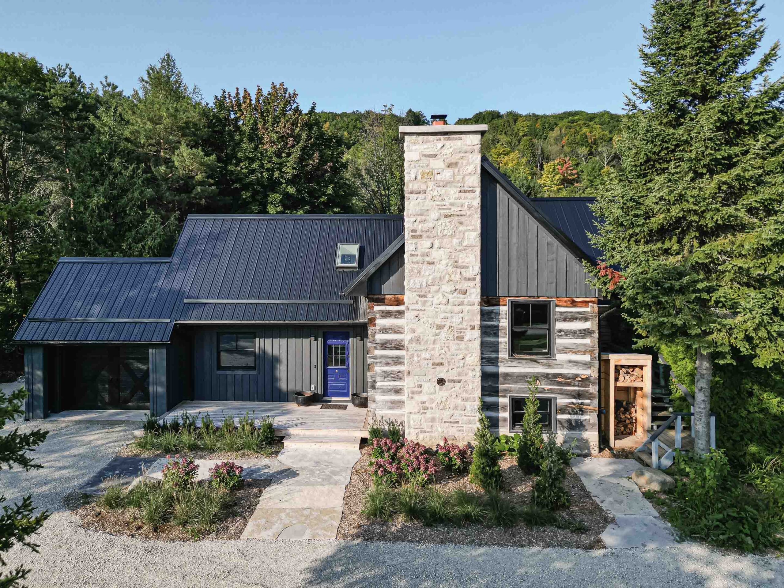 exterior of a rustic log cabin renovation with a contemporary addition, built by Blake Farrow Project