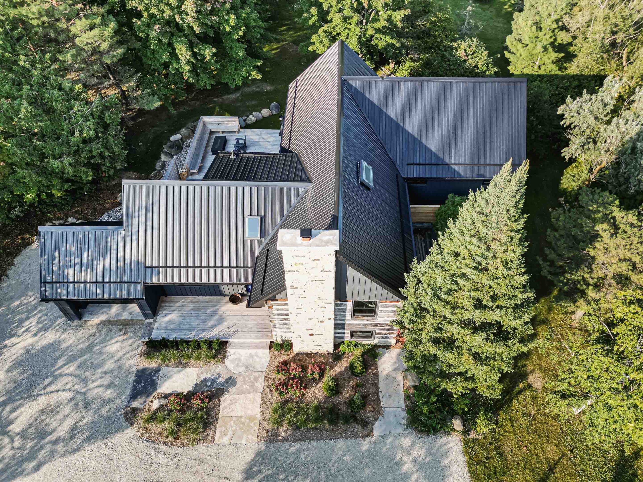 exterior of a rustic log cabin renovation with a contemporary addition, built by Blake Farrow Project