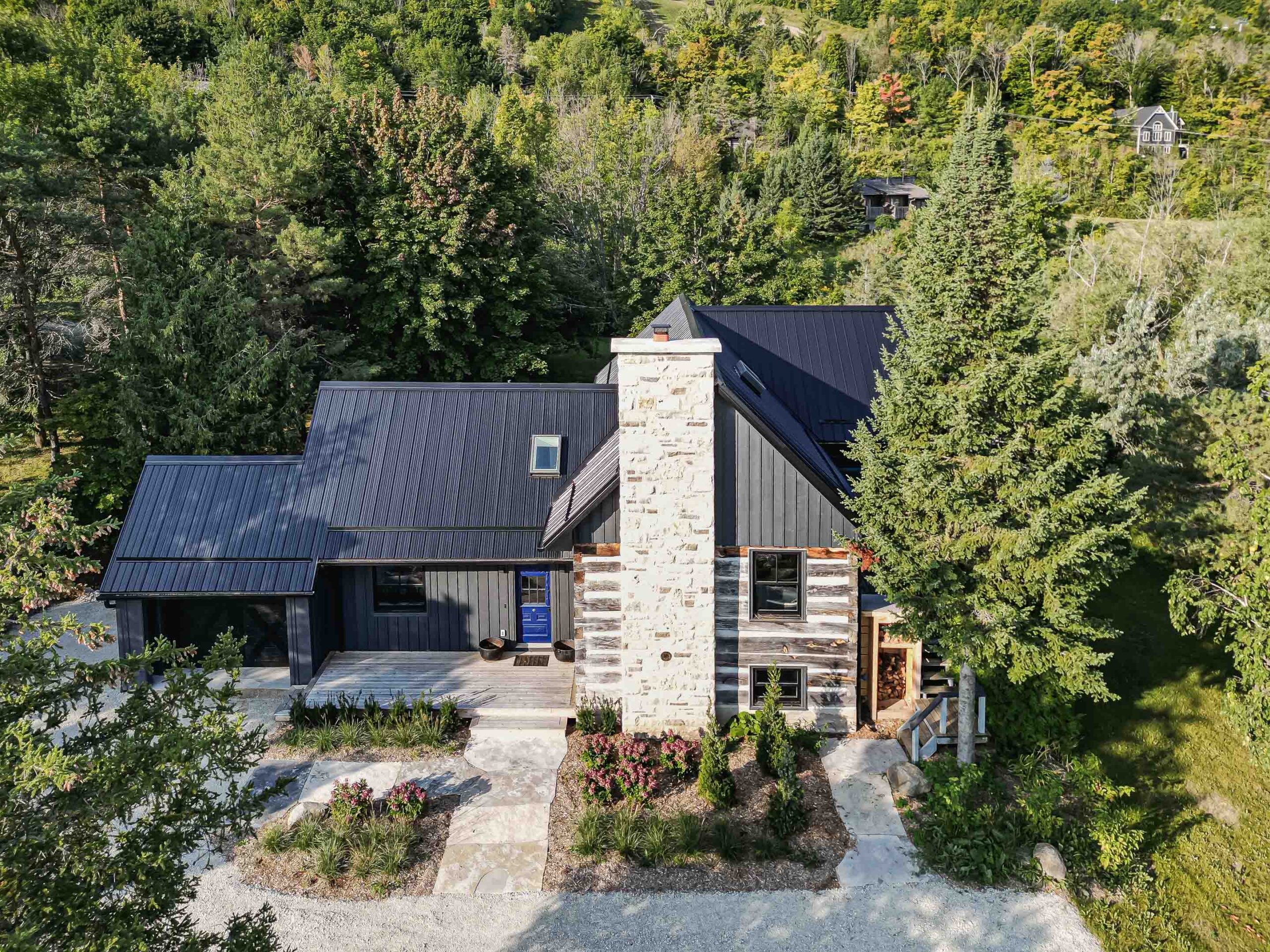 exterior of a rustic log cabin renovation with a contemporary addition, built by Blake Farrow Project