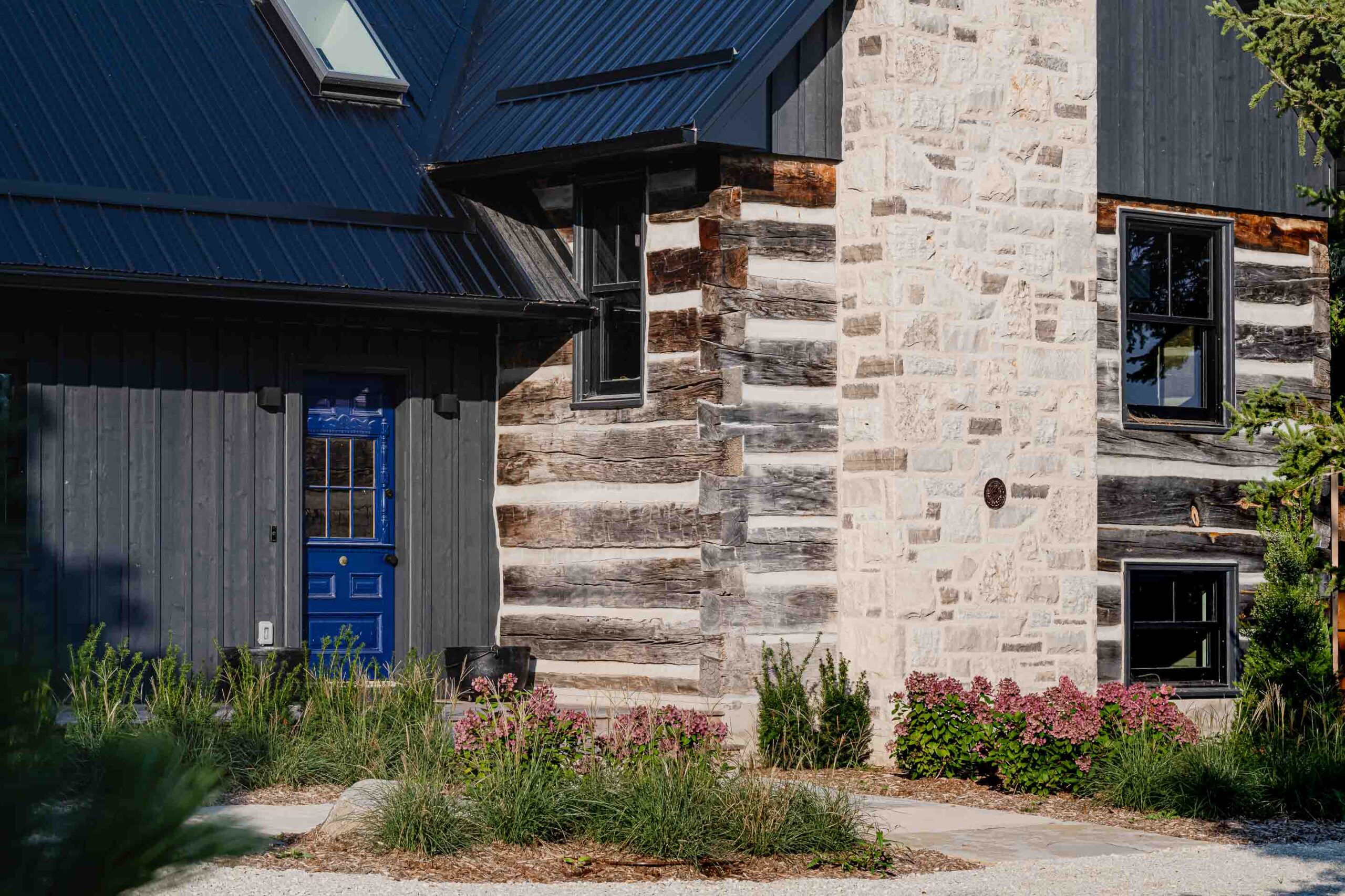 exterior of a rustic log cabin renovation with a contemporary addition, built by Blake Farrow Project