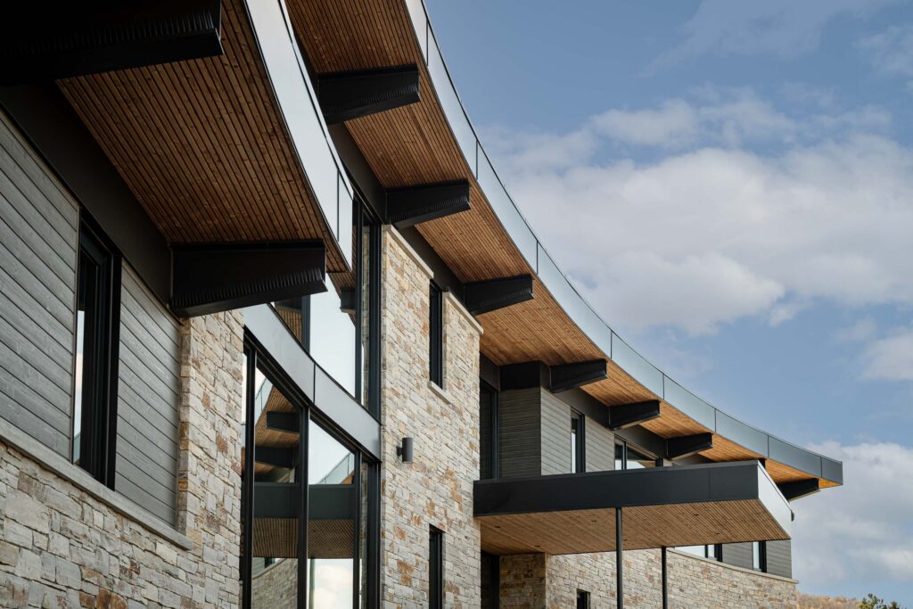 Contemporary chalet exterior with distinctive curved architecture