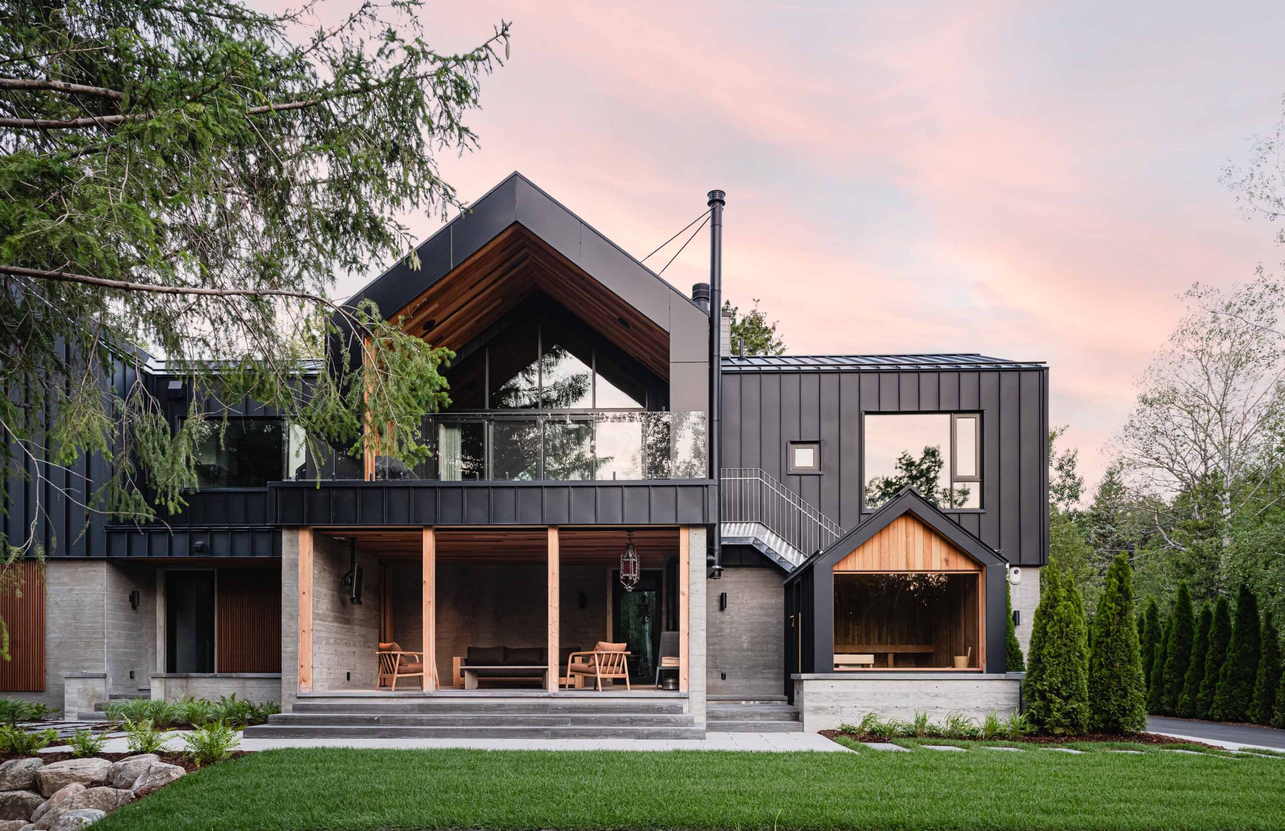 Contemporary Blue Mountain chalet rear elevation, with screened outdoor seating area, and attached sauna