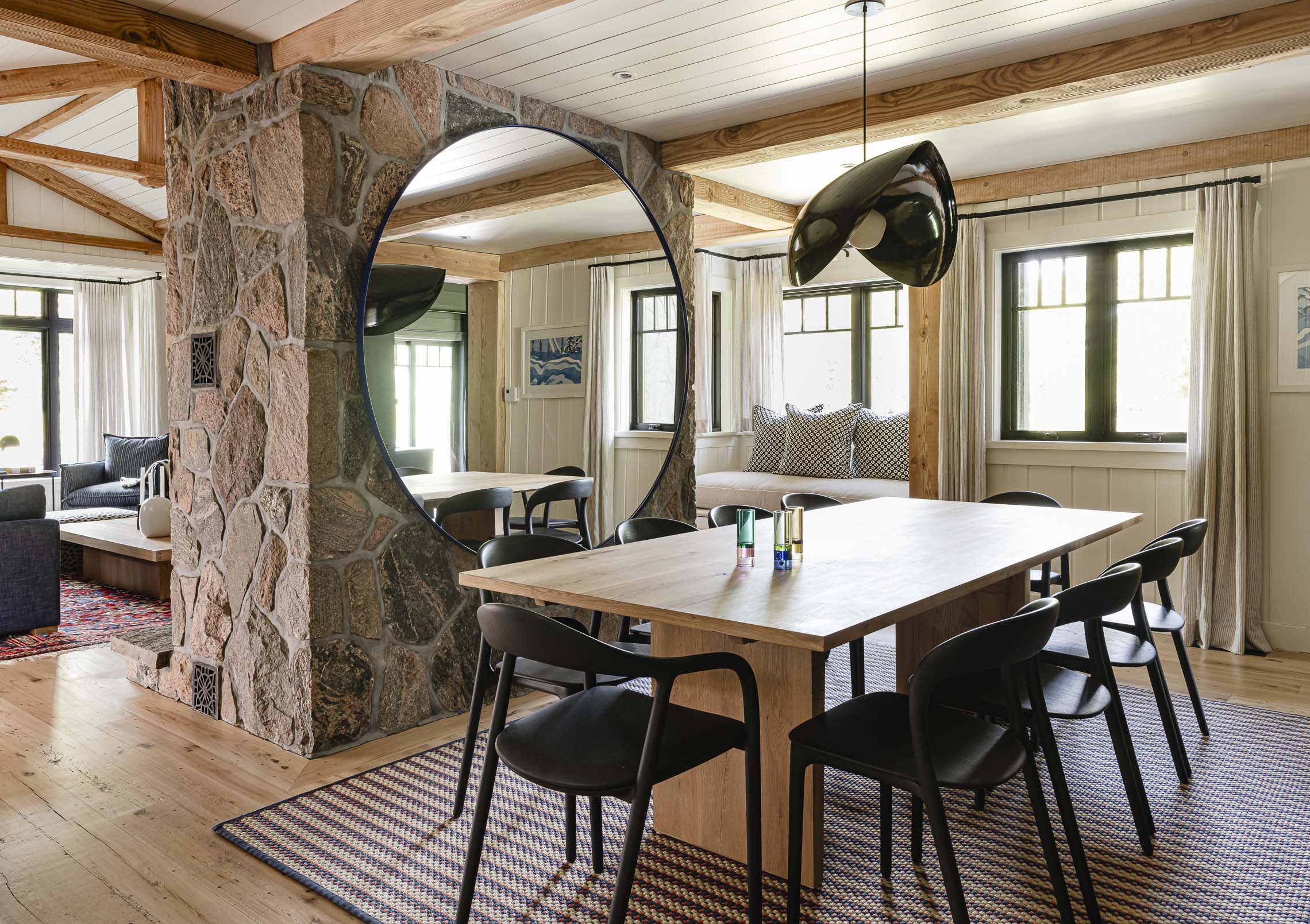 Dining area with exposed beams and textured finishes in renovated chalet