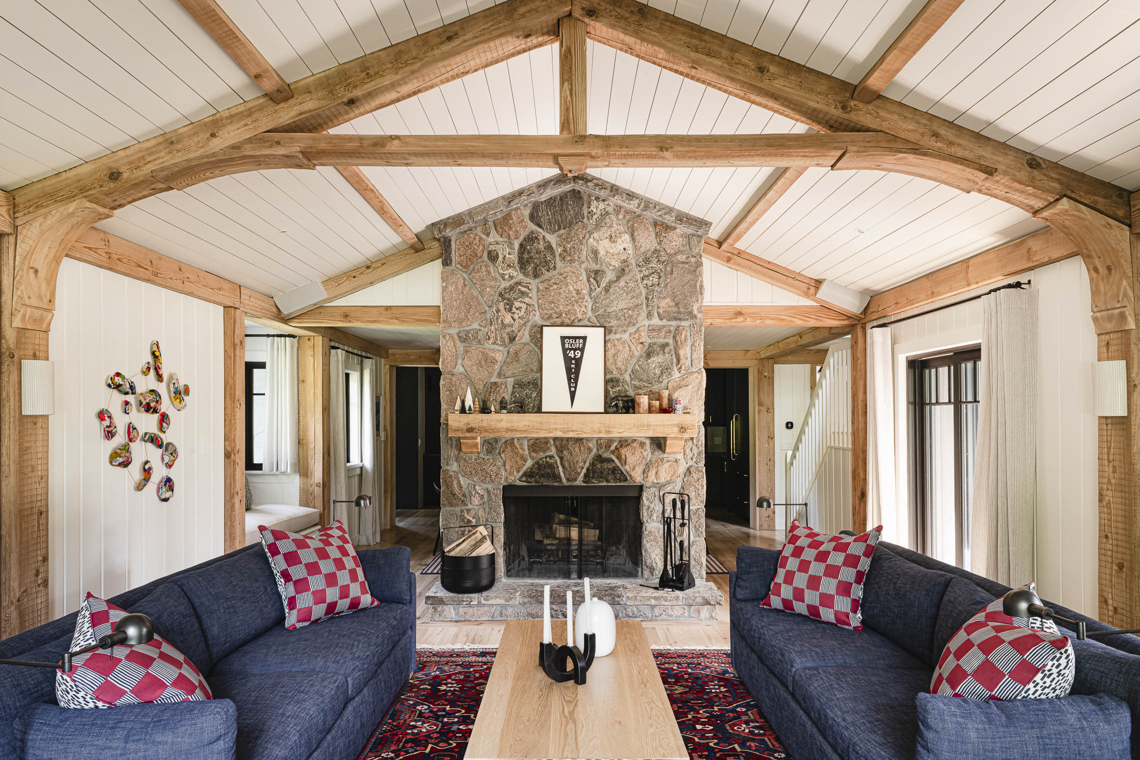 Restored wood beams and stone fireplace in Blue Mountain chalet living room