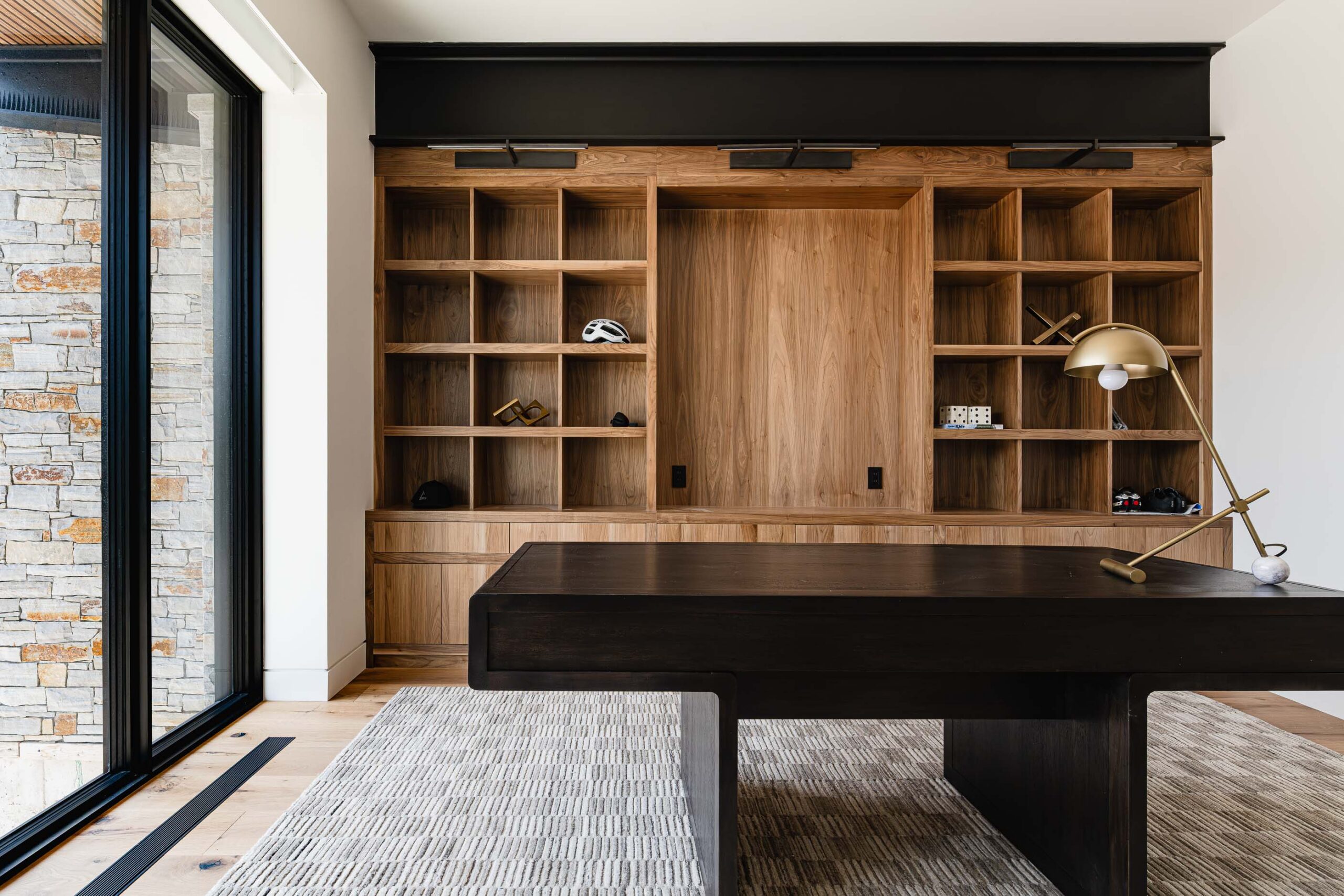 Modern home office with custom built-in shelving, industrial metal accenting, and contemporary finishings