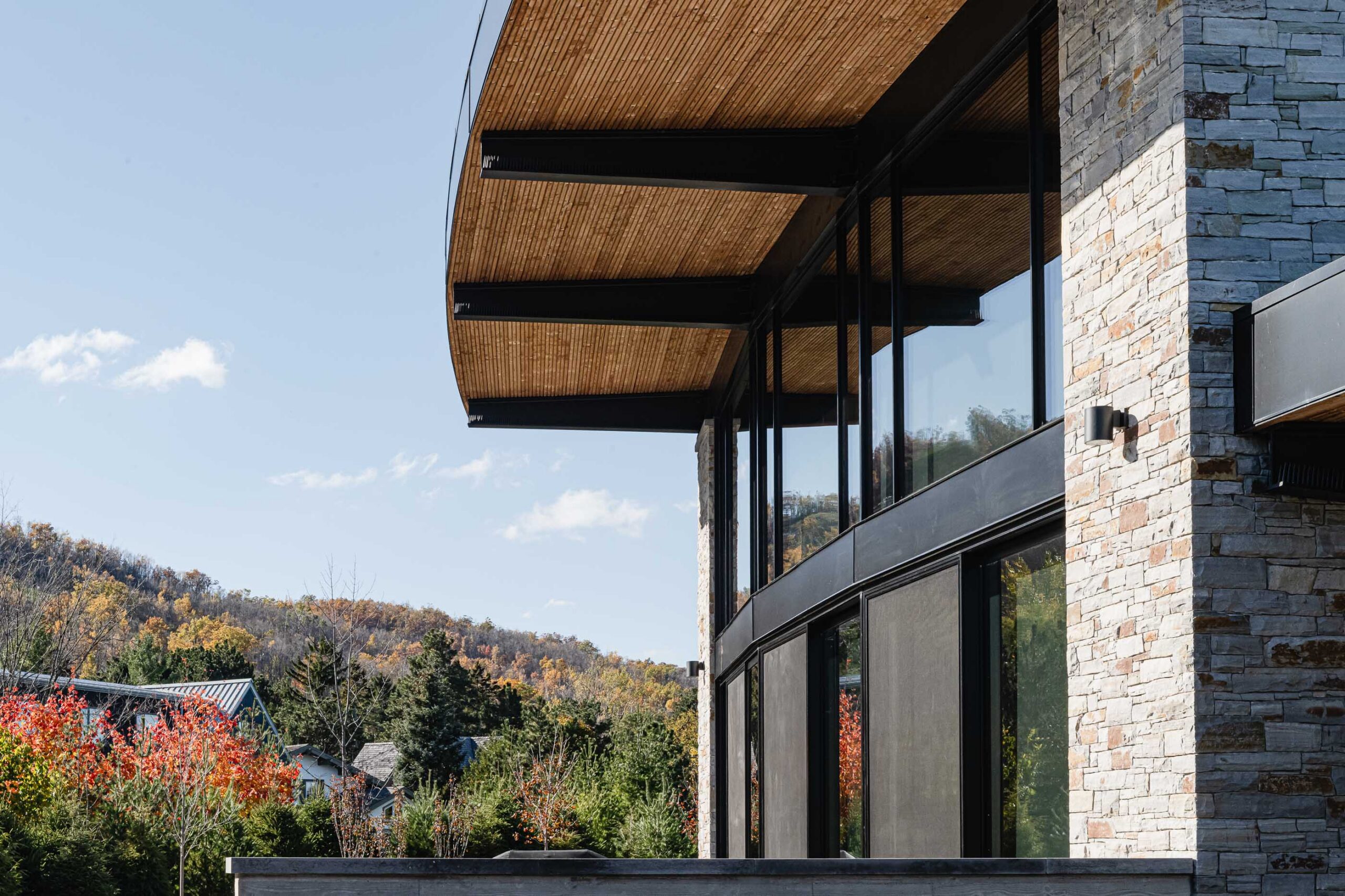 exterior detail of a modern Blue Mountain chalet with distinctive curved architecture