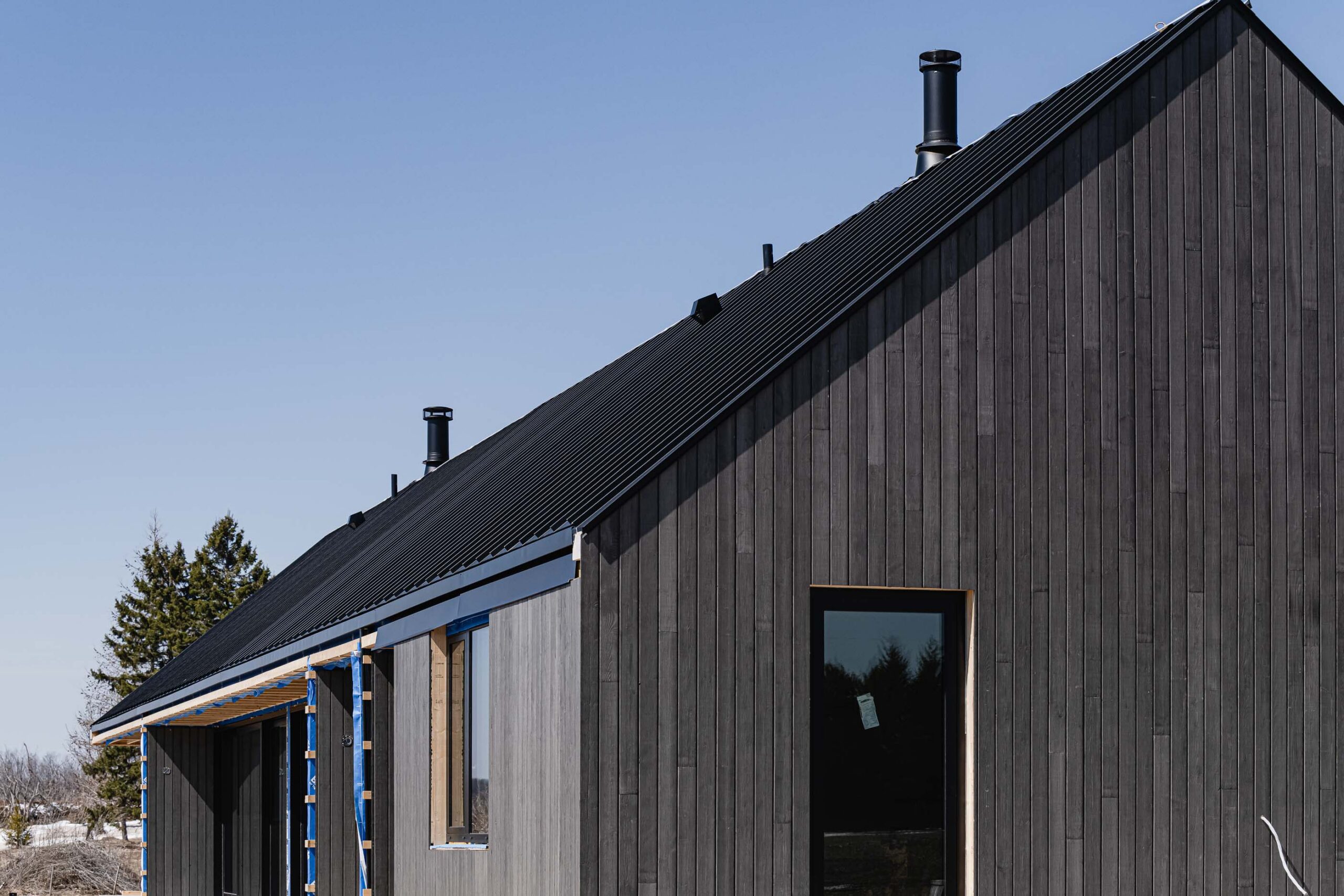 architectural details of a modern barn farmhouse being built by a Collingwood custom home builder
