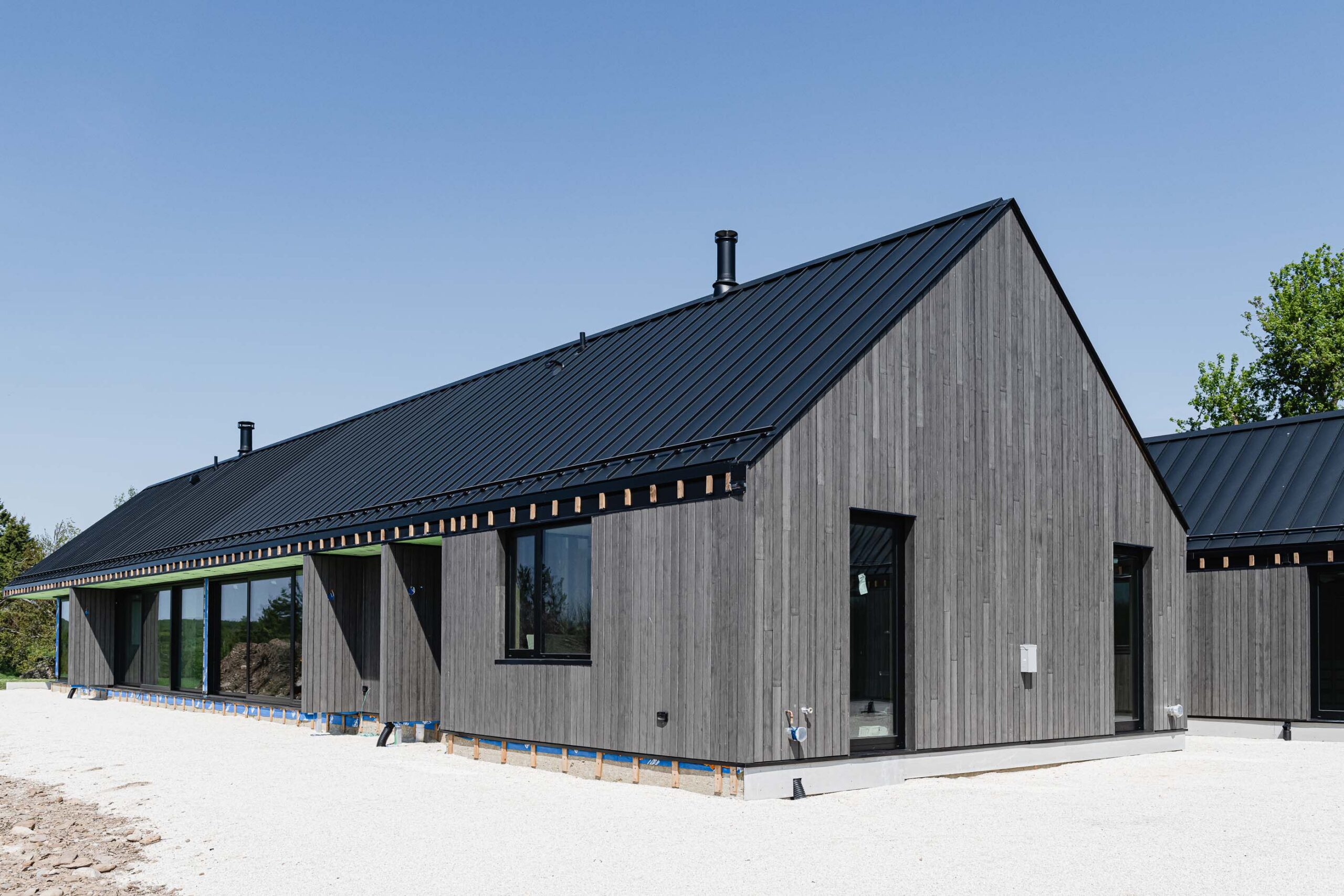 architectural details of a modern barn farmhouse being built by a Collingwood custom home builder