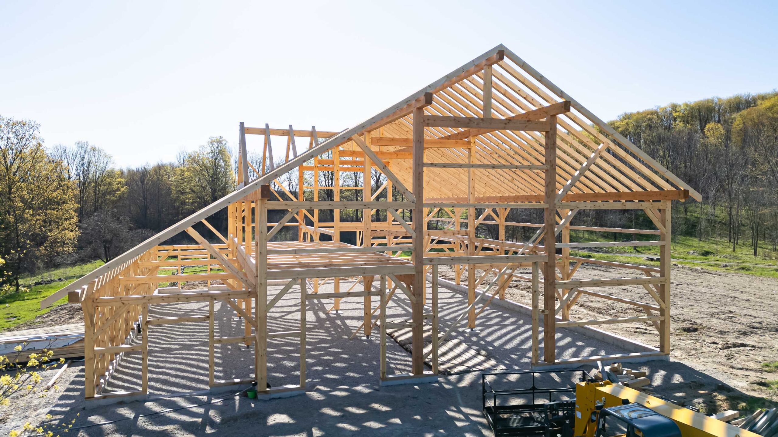 front elevation of a timber frame barn being constructed using traditional techniques