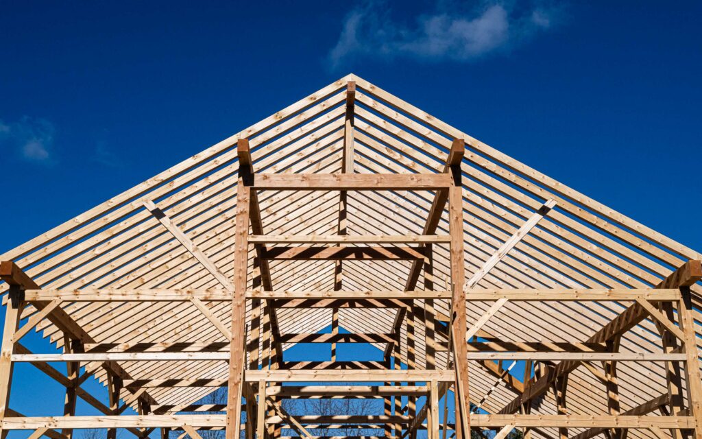 architectural detail of a framed modern timber frame barn in construction
