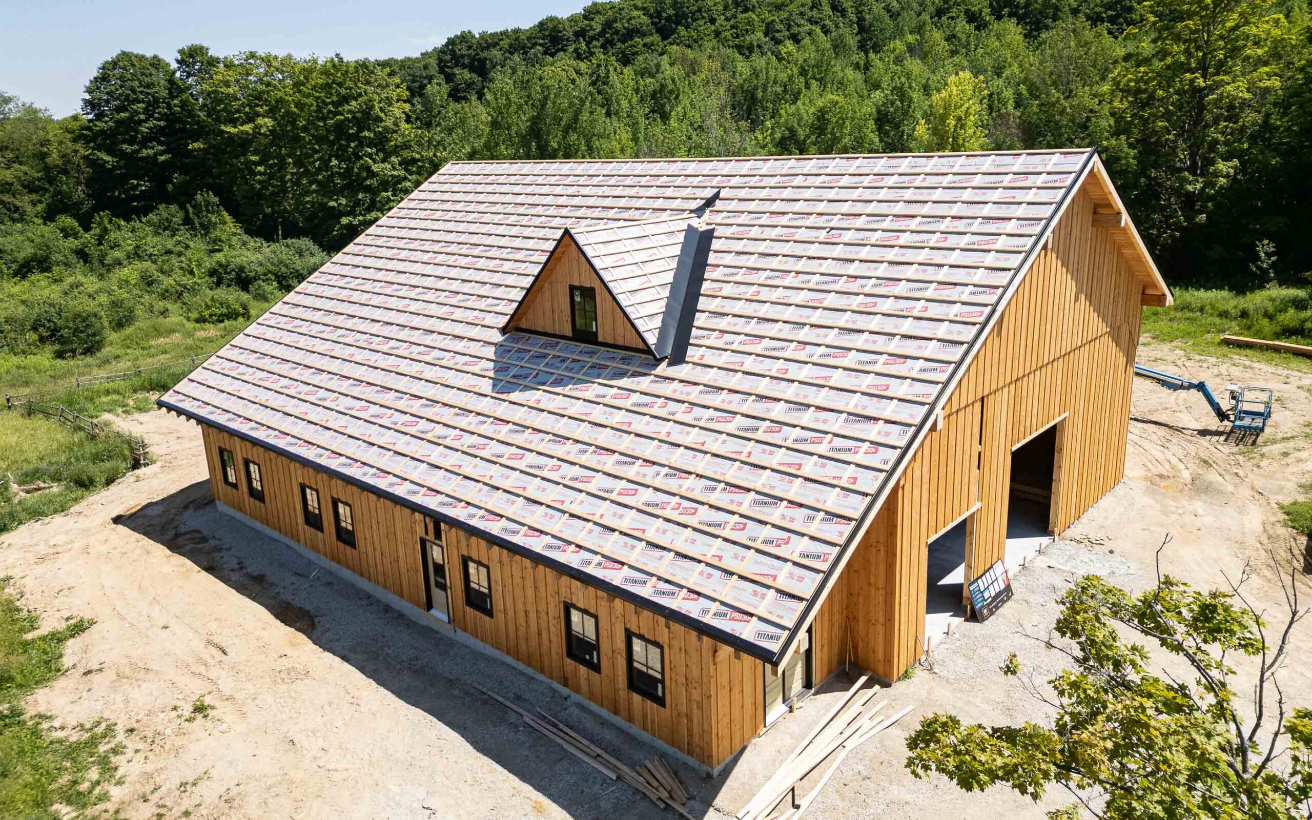 aerial view of the roofing detail on a modern timber frame barn in construction