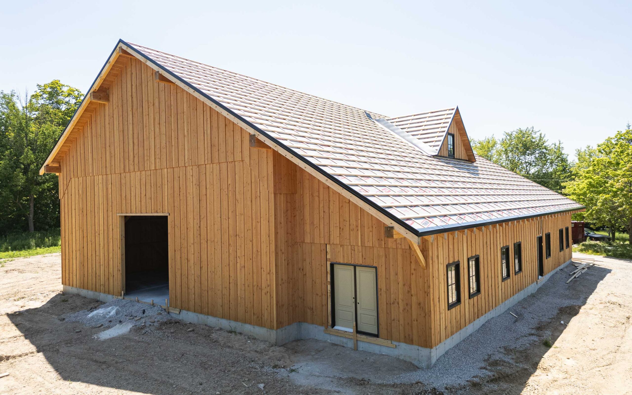 side elevation of a timber frame barn in construction