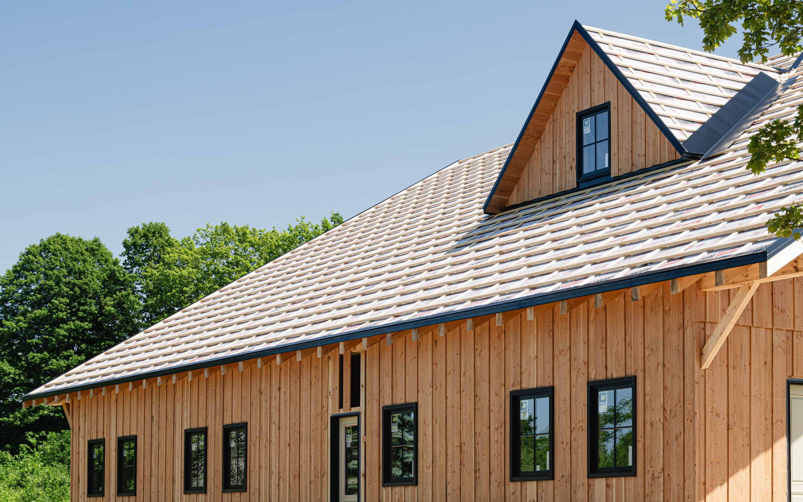 side elevation of a timber frame barn in construction