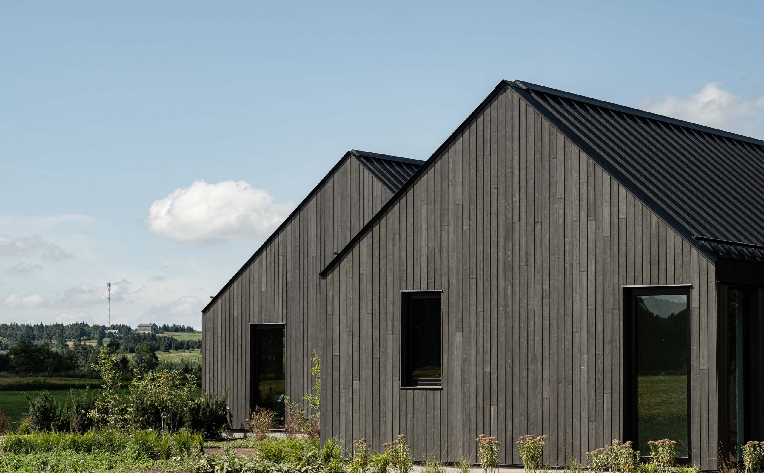 rear elevation of a Scandi-style modern barn with views of the surrounding farmland