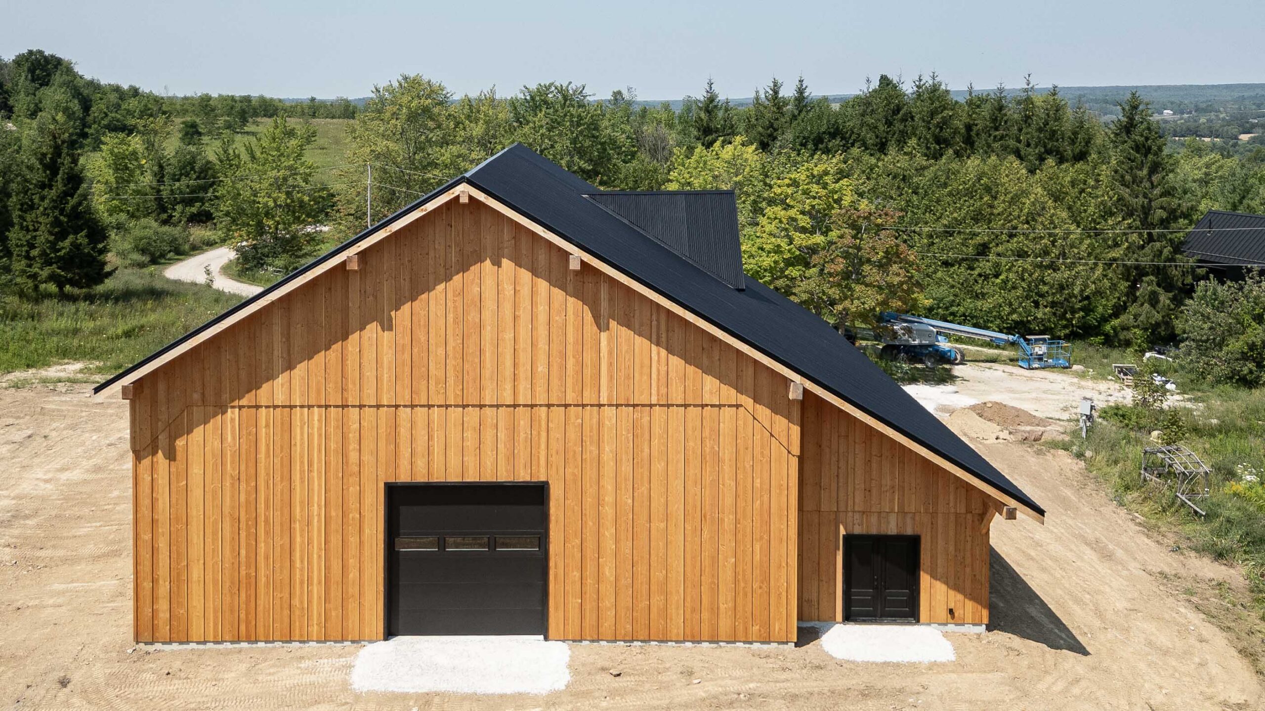 rear elevation of a modern timber frame barn built with traditional techniques