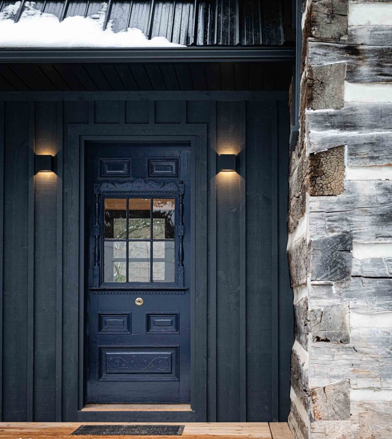 the original front door is integrated into the new addition on a log cabin renovation project by Blake Farrow Project