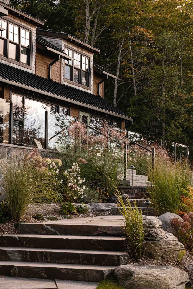 landscaping detail of a stone walkway with fall foliage, captured at dusk