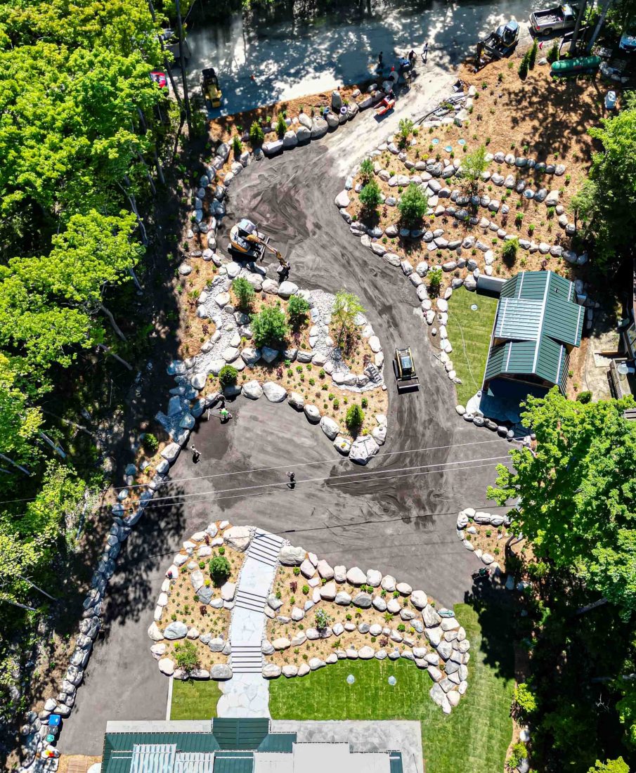 aerial view of a winding driveway with extensive landscaping