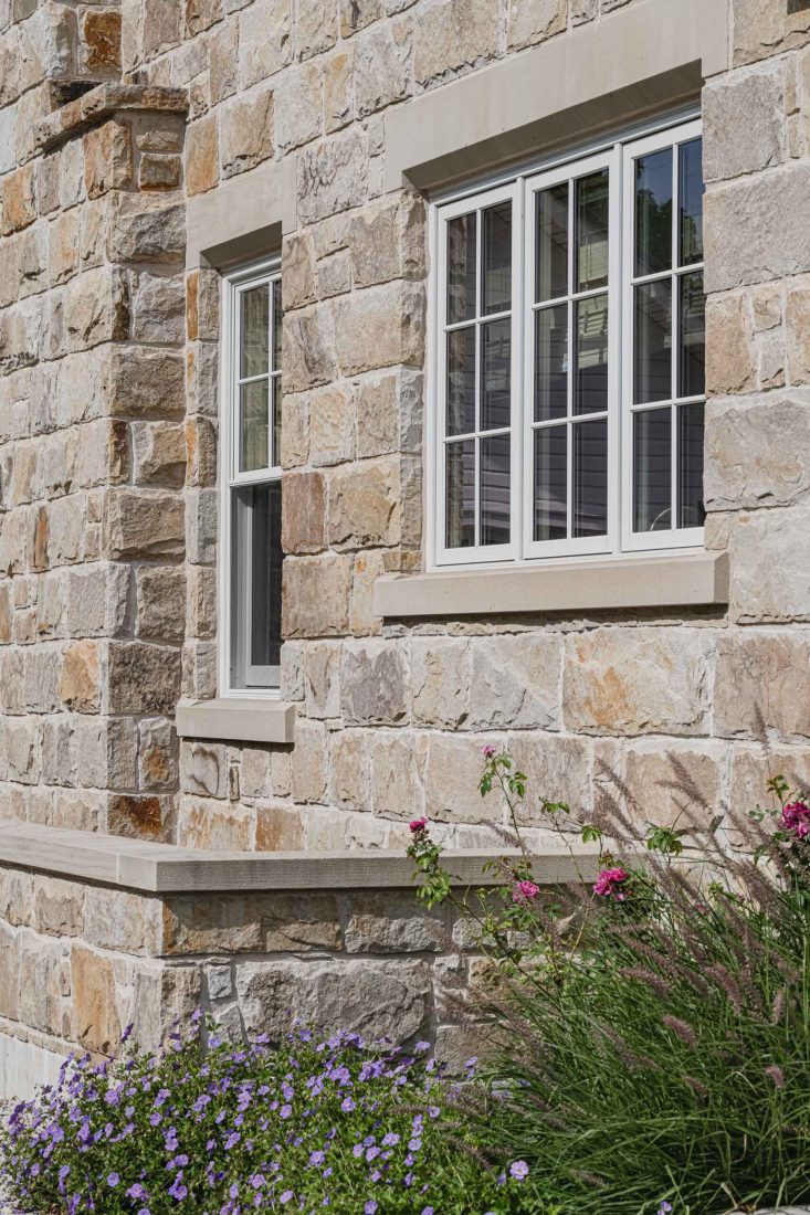 Stone masonry detailing on a English cottage-style stone house built by a Blue Mountain custom home builder