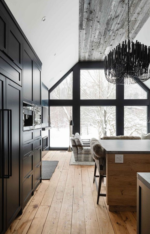 Dark moody kitchen in a modernized rustic chalet renovation by Blake Farrow Project, designed by FAD