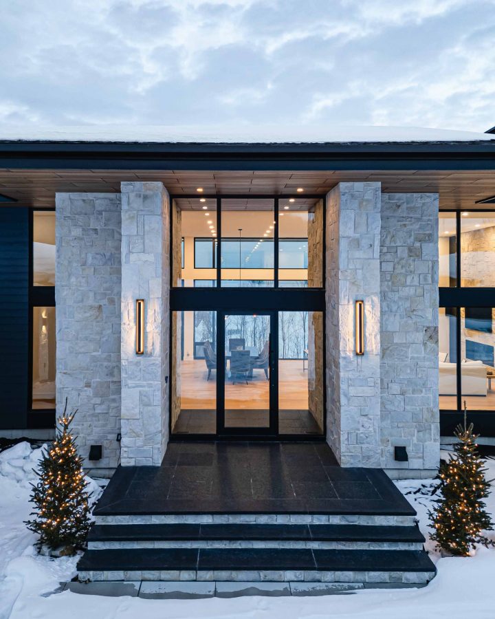 16-Contemporary-Country exterior of a contemporary country home with floor to ceiling glass, photographed at dusk
