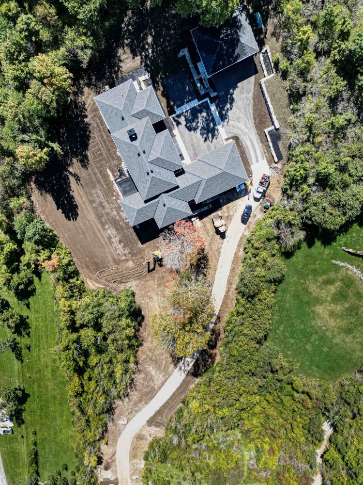 birds eye view of a sprawling country home in construction, shot in the fall