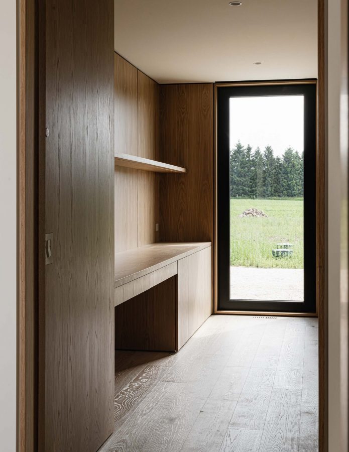 Interior detail of a modern study being built, with custom oak built-in desk and paneling