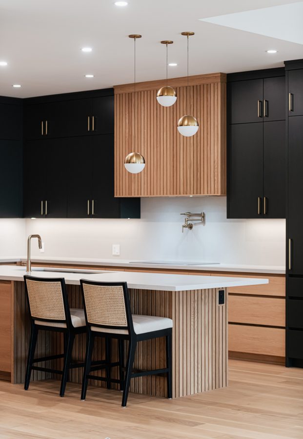 Contemporary beach house kitchen featuring fluted wood and custom millwork