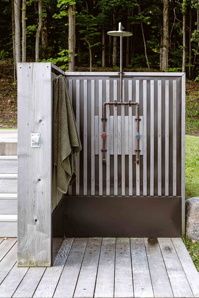 detail of an outdoor shower with modern lines and industrial hardware, built by Blake Farrow Project