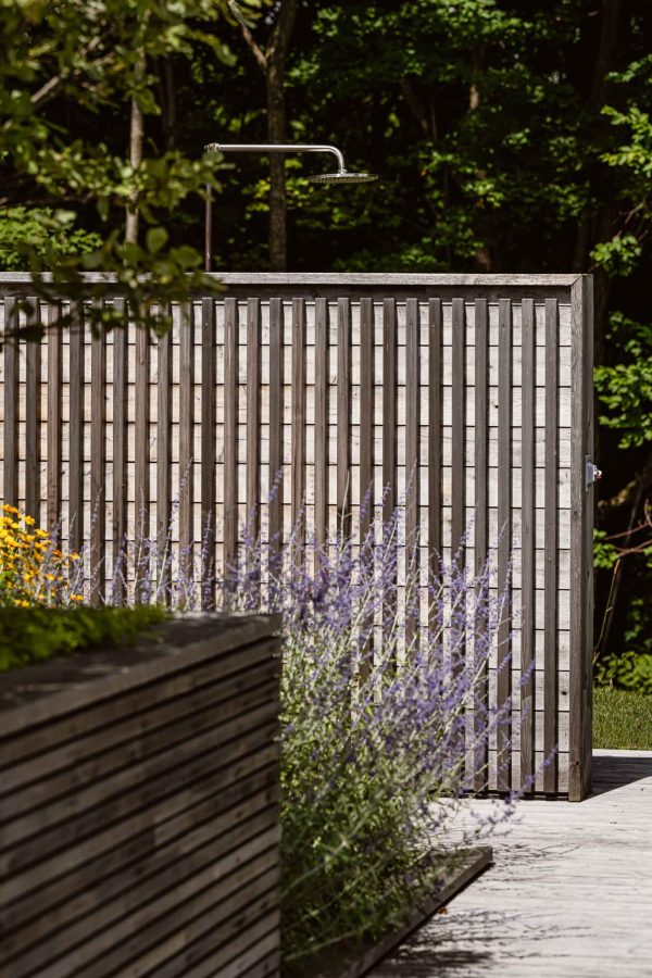 detail of an outdoor shower with modern lines and industrial hardware, built by Blake Farrow Project