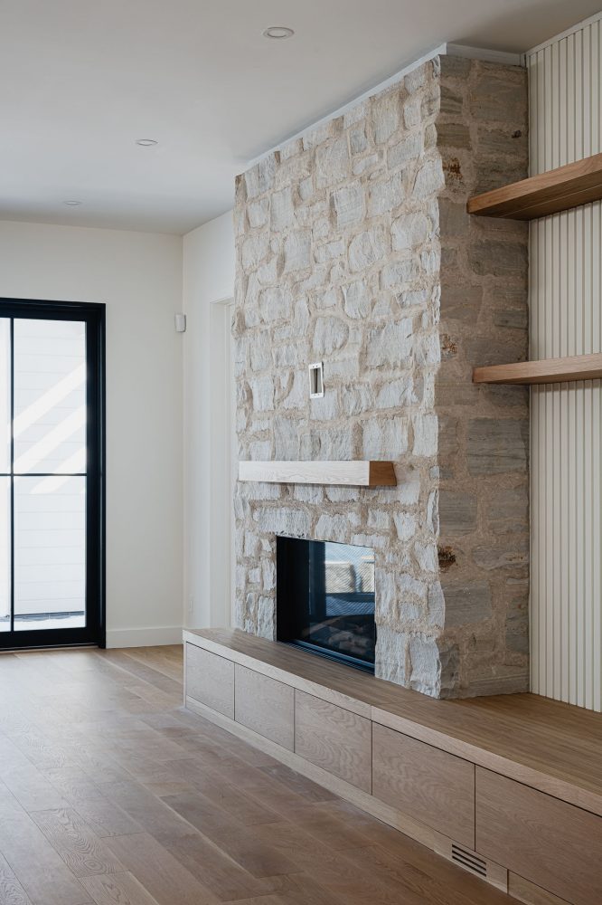 stone fireplace detail in a modern beach house built by Collingwood custom home builder