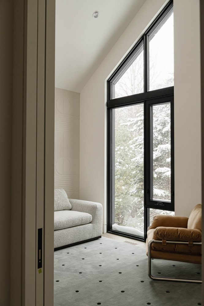Contemporary Blue Mountain chalet office detail with textured wallpaper, angled black-framed windows and modern furnishings