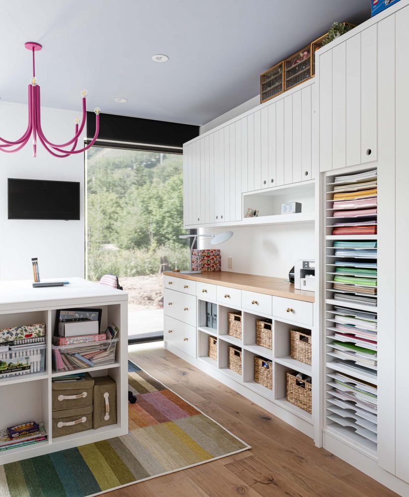 Custom contemporary craft room with purpose-built cabinets, shelving and work surfaces in a Blue Mountain home