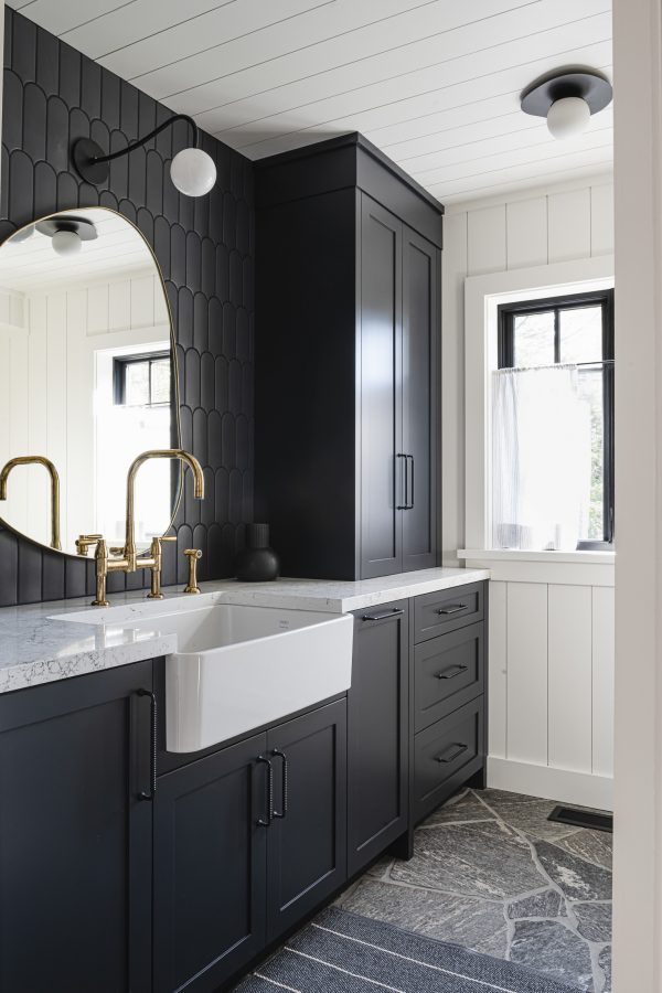 dark, rich millwork and tiling in a blue mountain chalet laundry room