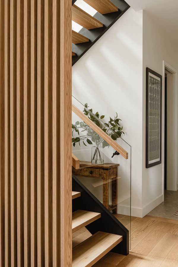 Slat wood and glass walled staircase detail in a luxury Blue Mountain home