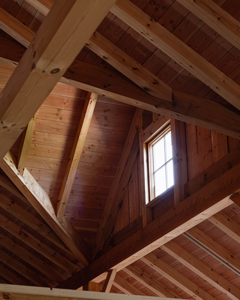 interior roof detail of a modern timber frame barn