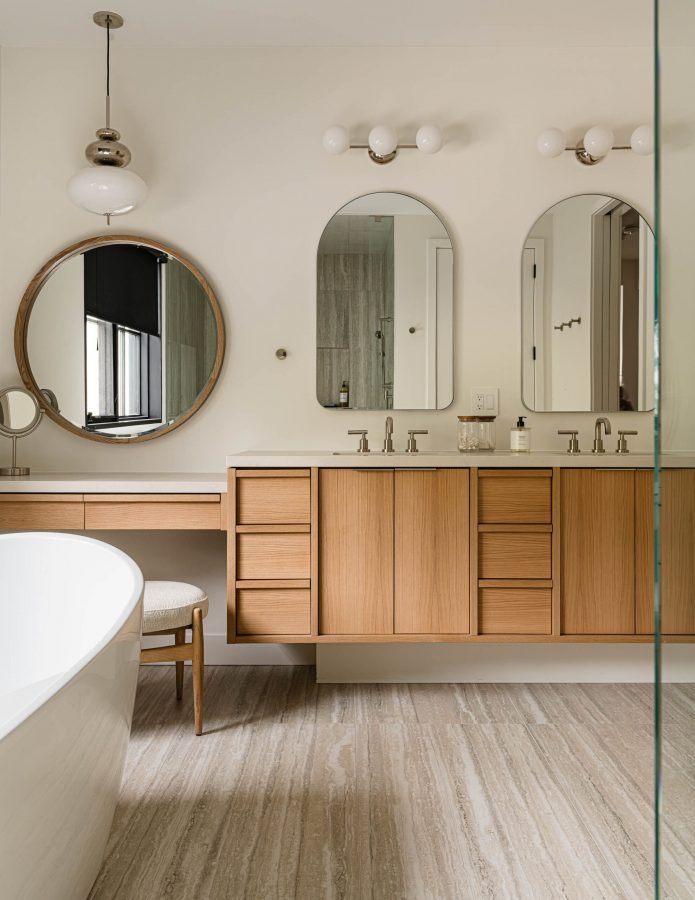Custom floating vanity, quartz counters and modern standing tub in a luxury primary suite bathroom