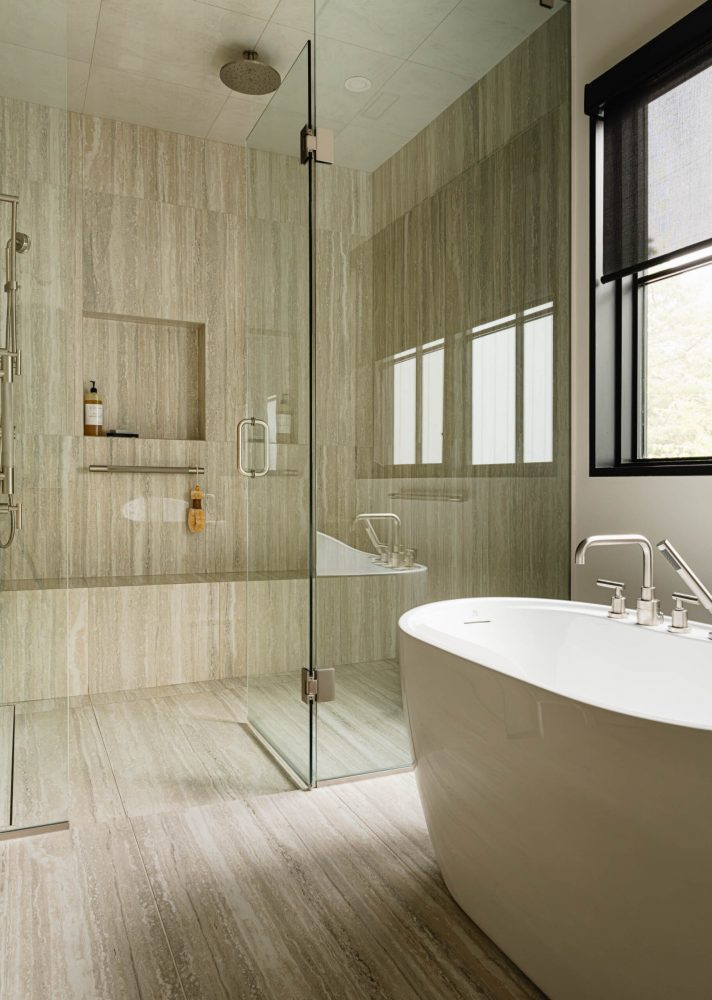 Contemporary bathroom with oversized, glass walled shower with custom tiling, and modern standing tub